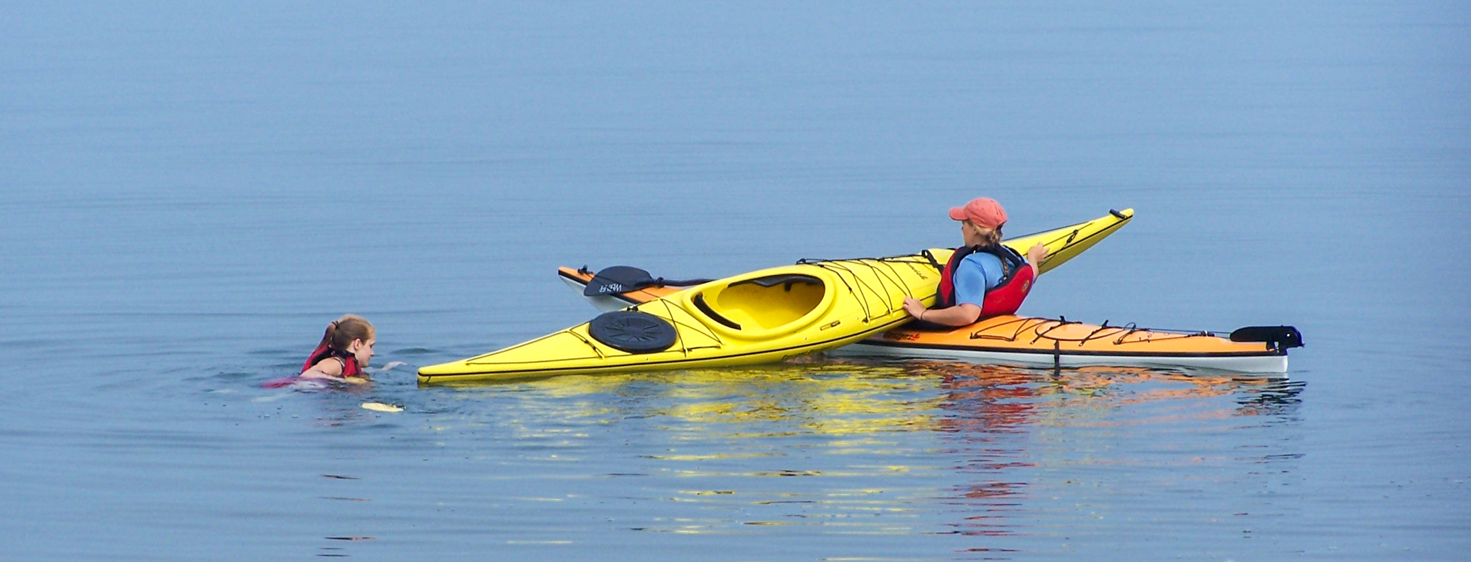 Photograph of kayakers in water.