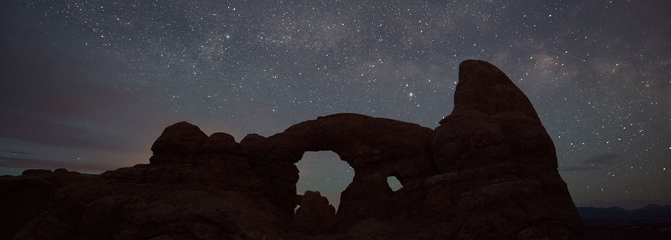 stars above a silhouetted Turret Arch