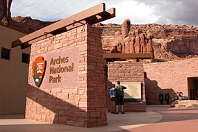 A brick and stone building with an "Arches National Park" sign.