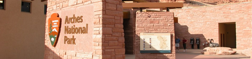 brick building structures with a sign reading Arches National Park