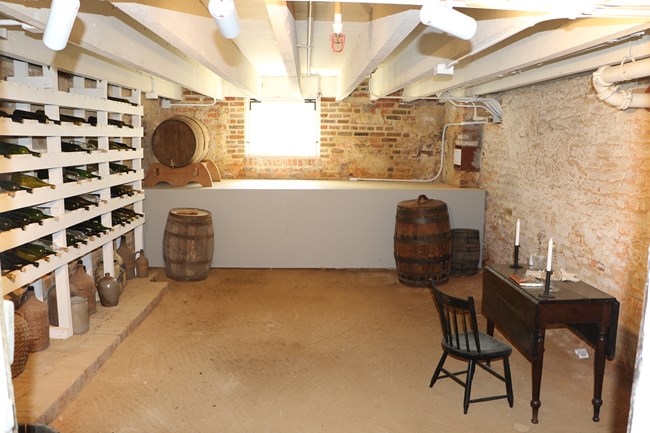 A wine cellar with a desk inside.