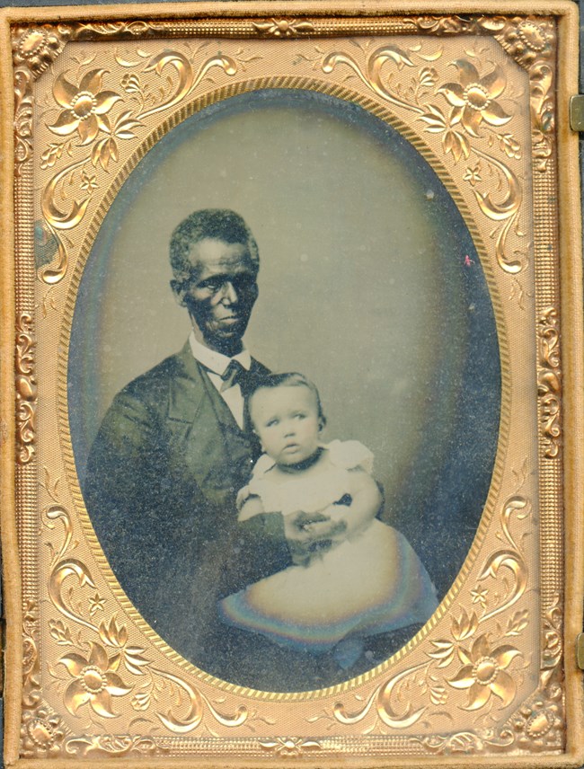 An older person holding a baby.