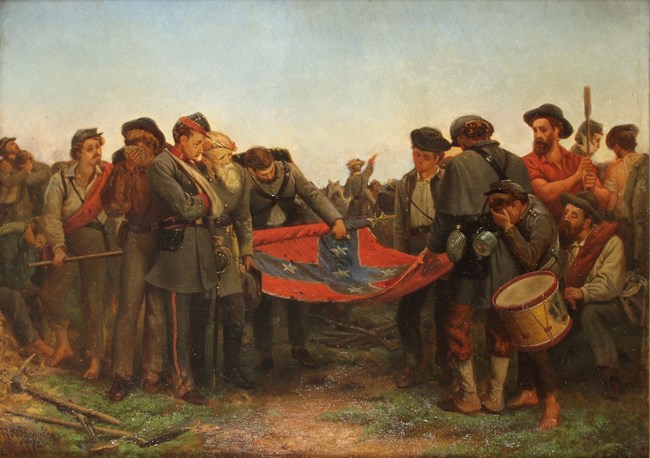 Confederate soldiers surrender their flags.