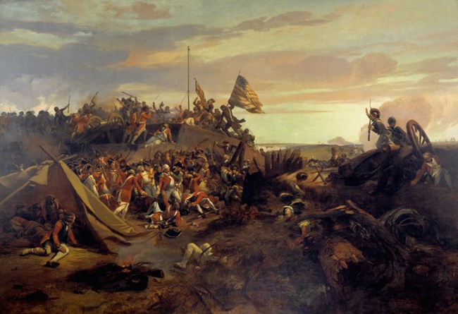 A swarm of soldiers in various uniforms storm a small incline, weapons aimed at the opposite forces.