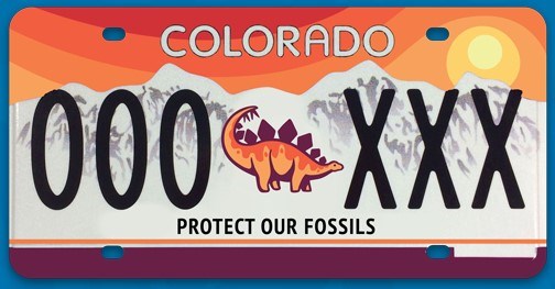 Image of Colorado license plate with numbers, dinosaur, mountains, and sun
