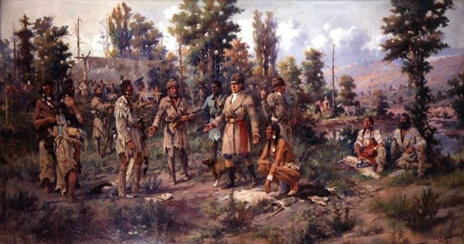 A painting shows Lewis and Clark meeting with Native people in a wooded setting. Sacagawea and Charbonneau are seated on the ground at the far right of the painting.