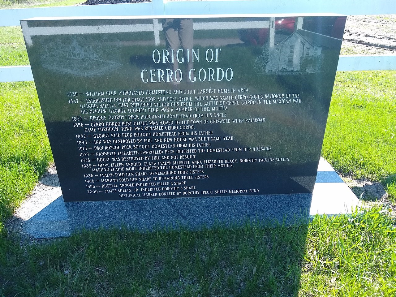 Dark stone marker describing the origin of the town of Cerro Gordo