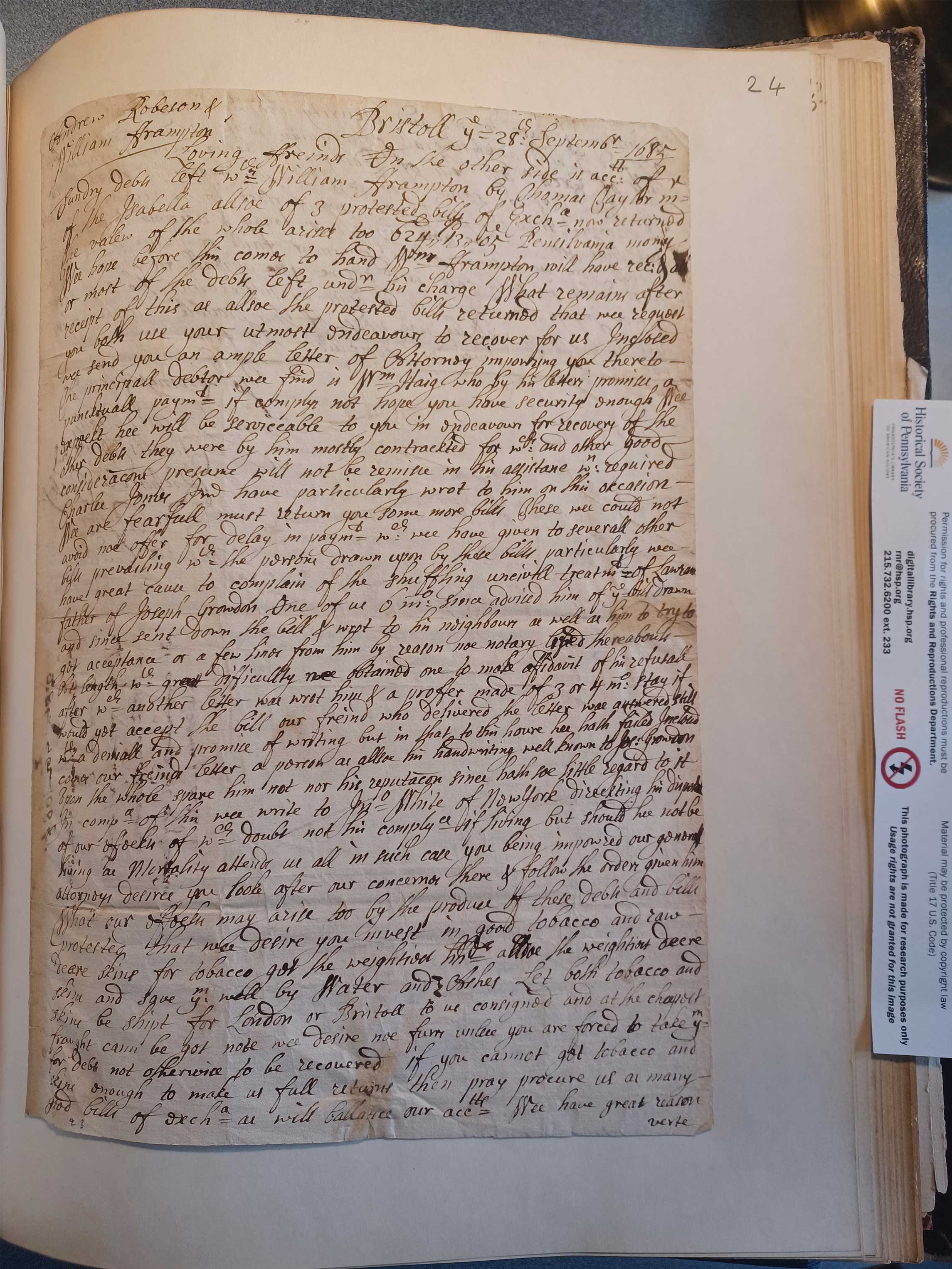 black ink handwriting on paper attached to a page of a book