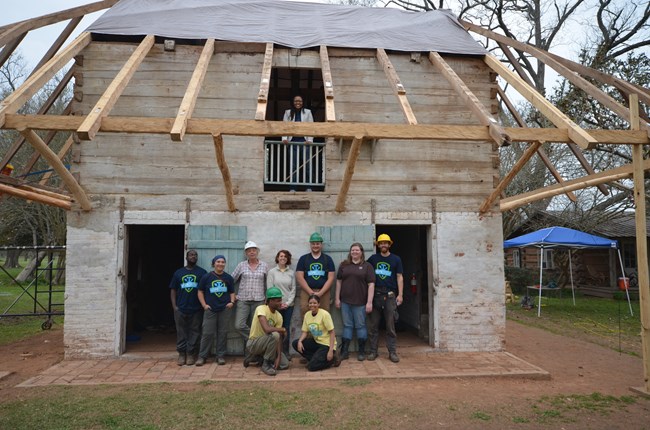 The HOPE Crew team pauses for a photo after completing the major framing work.