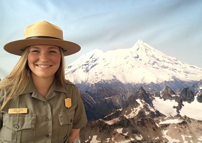 Woman in uniform with volcano in background