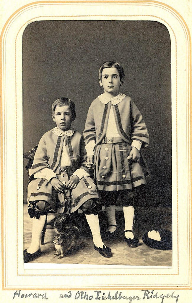 A historic black and white image of two young children.