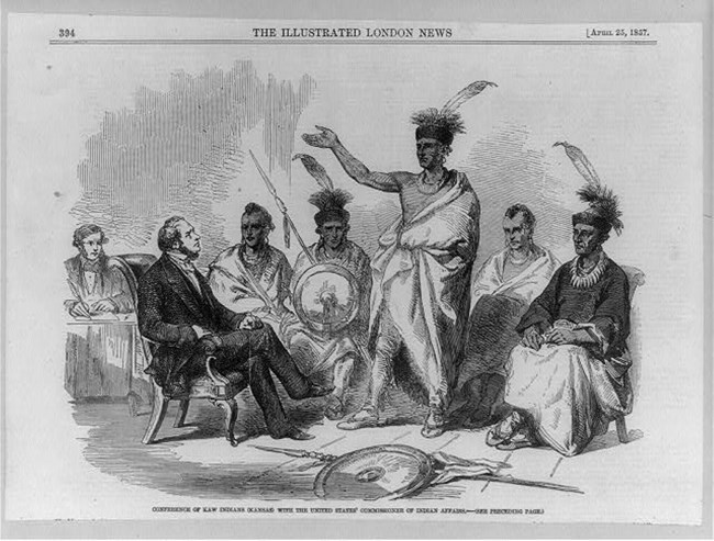 Newspaper illustration showing seated men in suits and several standing men in traditional Kaw clothing.