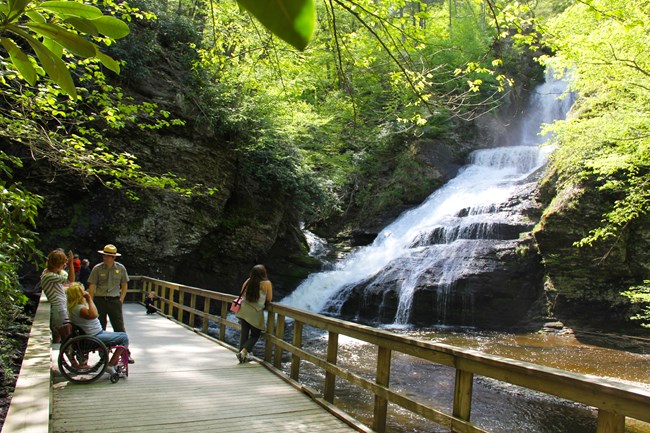 Visitors and a Ranger gather at the observation area along the Dingmans Falls Boardwalk