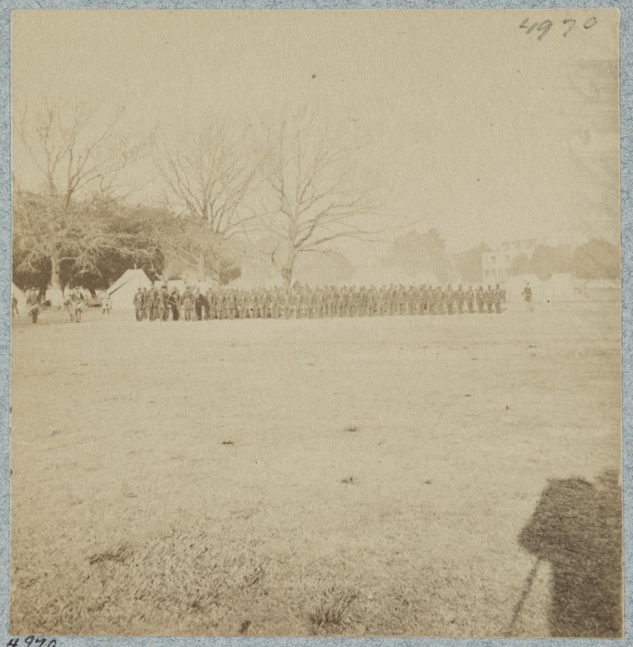 A military regiment lined up marching.