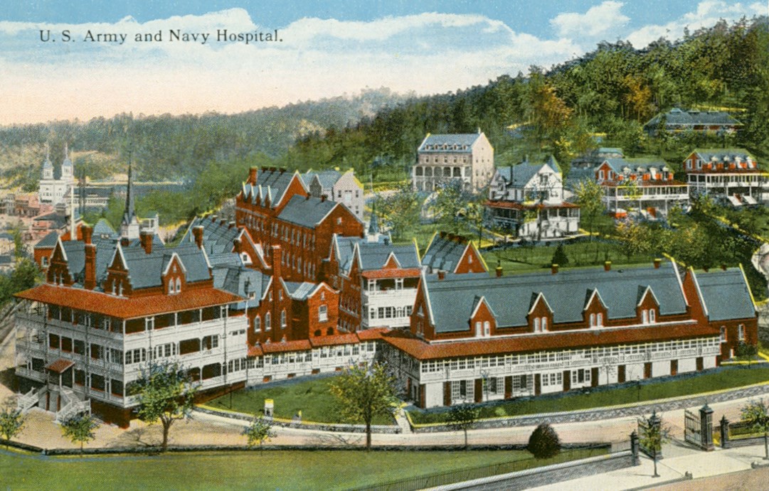 Illustration of a wooden and brick building. The wood is painted white and the brick is read. The buildings have blue roofing and it sits at the bottom of a steep hill filled with green trees.