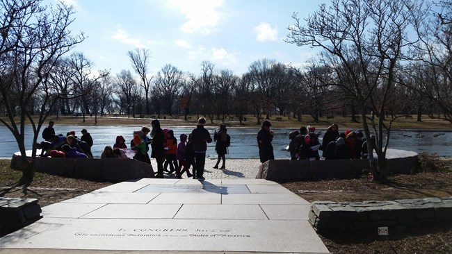 Group of children exploring 56 signers memorial
