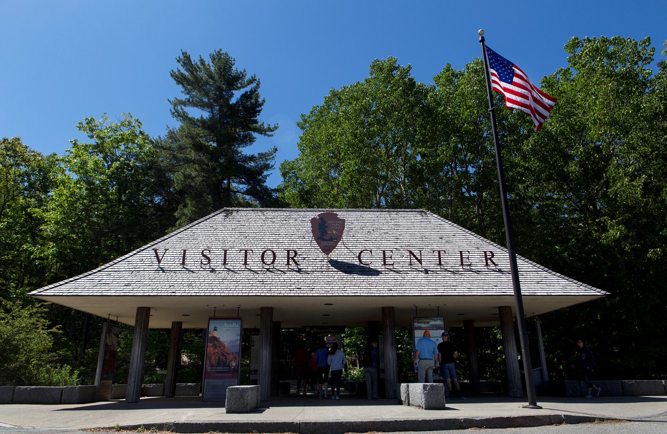 Pavilion with information displays next to a parking lot