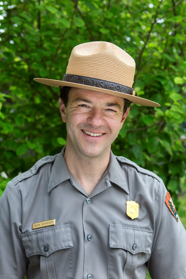 Portrait of a smiling map wearing a park ranger flat hat