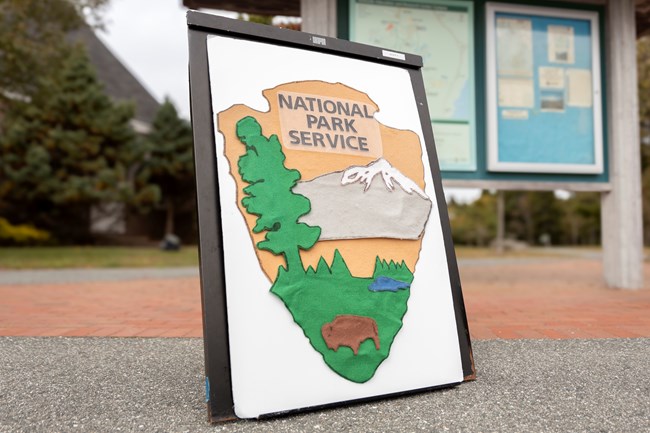 National Park Service arrowhead logo consisting of various pieces of felt that form the logo.
