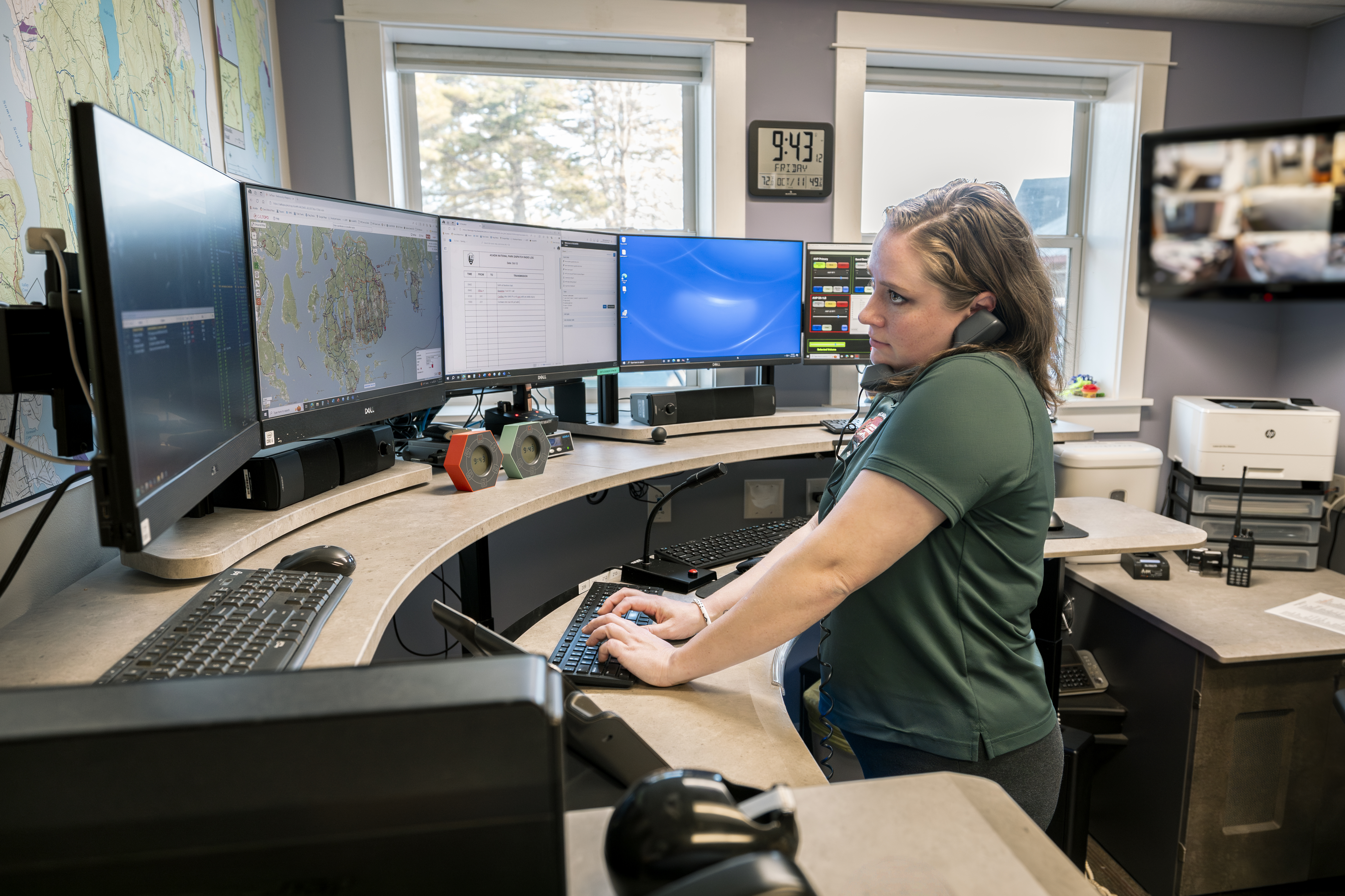 Woman talks on the phone with EMS agencies when responding to an incoming 911 call.