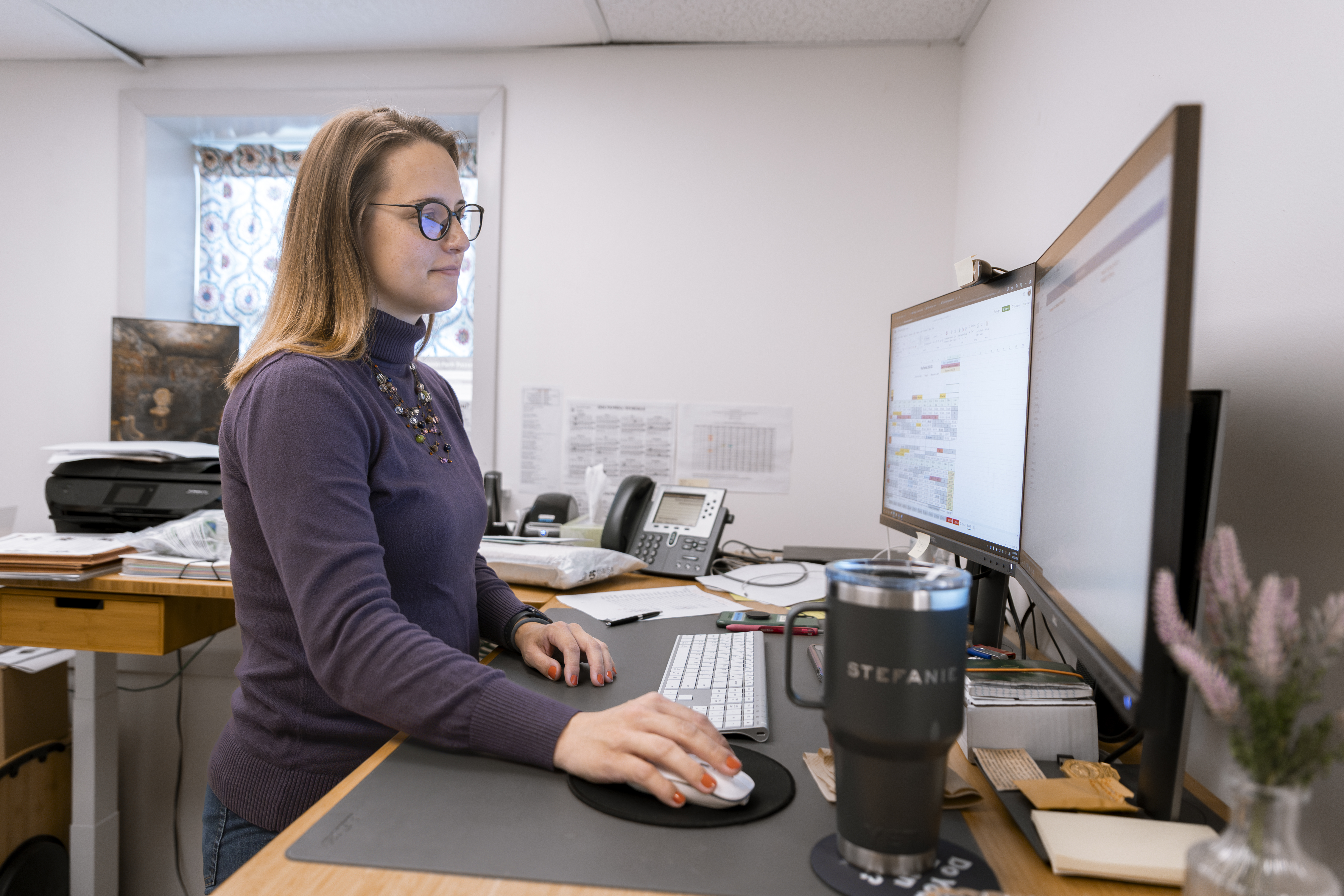 Woman works at an office desk.