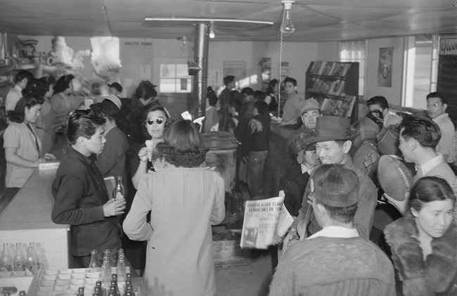 A crowd inside a large room used as a store
