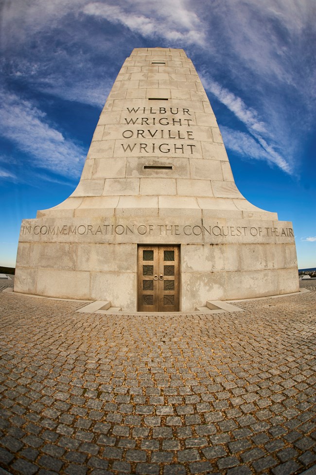 Monument with inscriptions "Wilbur Wright, Orville Wright" and "In Commemoration of the Conquest of the Air"