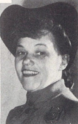 A black and white photo of a White woman smiling at the camera.