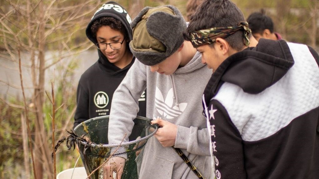 Schoolchildren participating in a wetland conservation experiential activity.