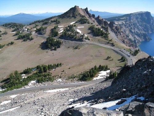 A stretch of West Rim Drive curving around peaks
