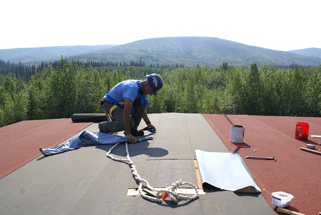 A man installs a new roof.