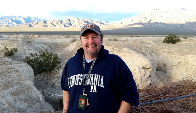NPS Senior Paleontologist Vincent Santucci outside at Tule Springs Fossil Beds National Monument smiling at the camera.