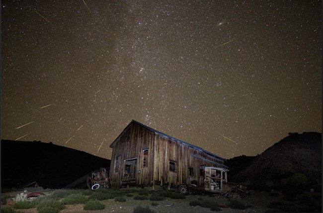 Wooden structure surrounded by starry night sky