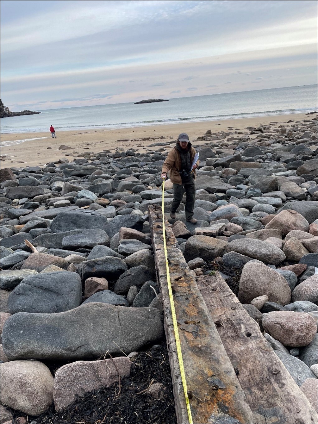 Person uses measuring tape on a length of wood