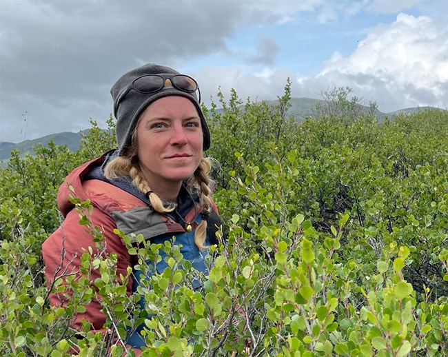 A woman in a field in Alaska.