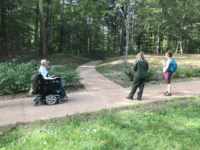 A group of people experience the accessible trail at Lincoln Boyhood National Memorial.