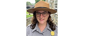 Smiling woman in NPS uniform and hat