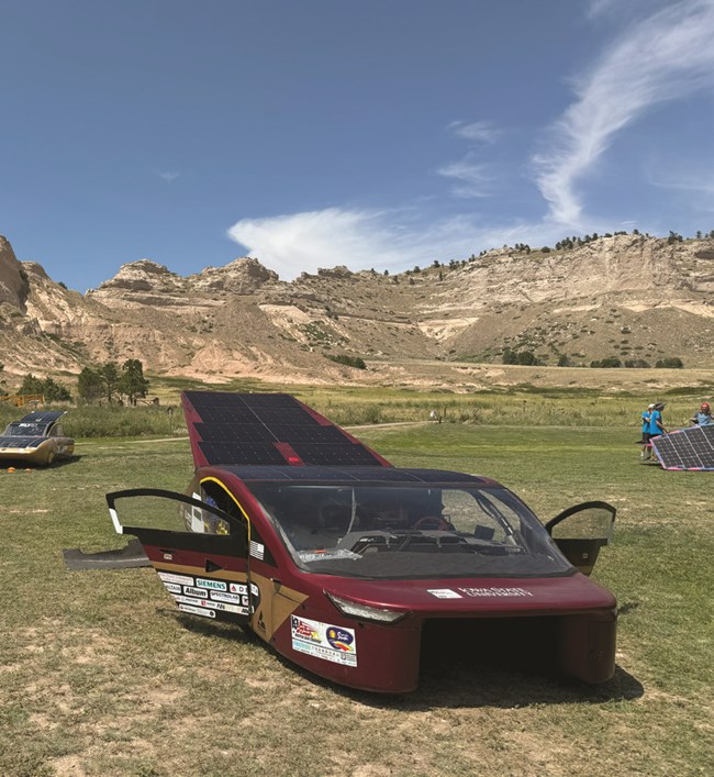 A red electric vehicle on a field