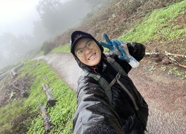 A woman smiling outdoors
