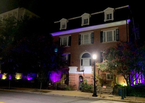 Exterior of Belmont Paul with purple and gold lights for 19th Amendment Centennial