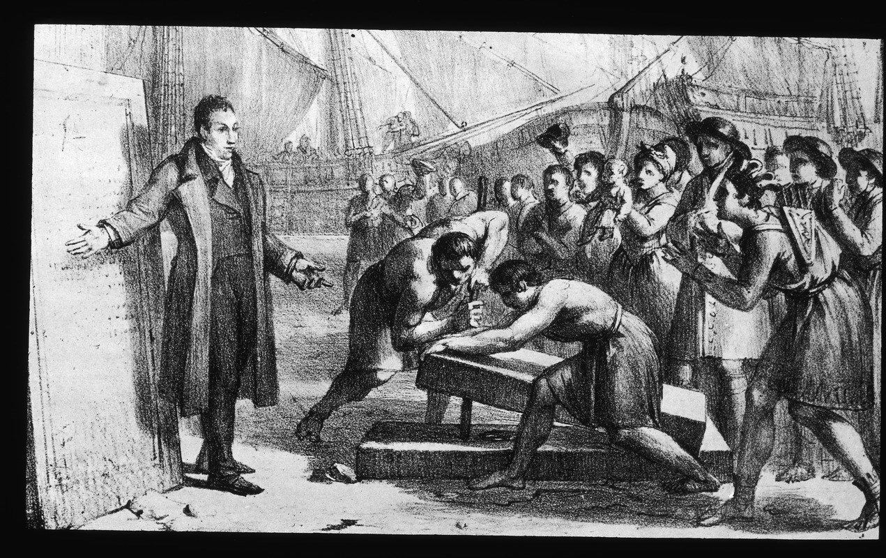 Lafayette speaks as people watch a stone being placed on the ground.