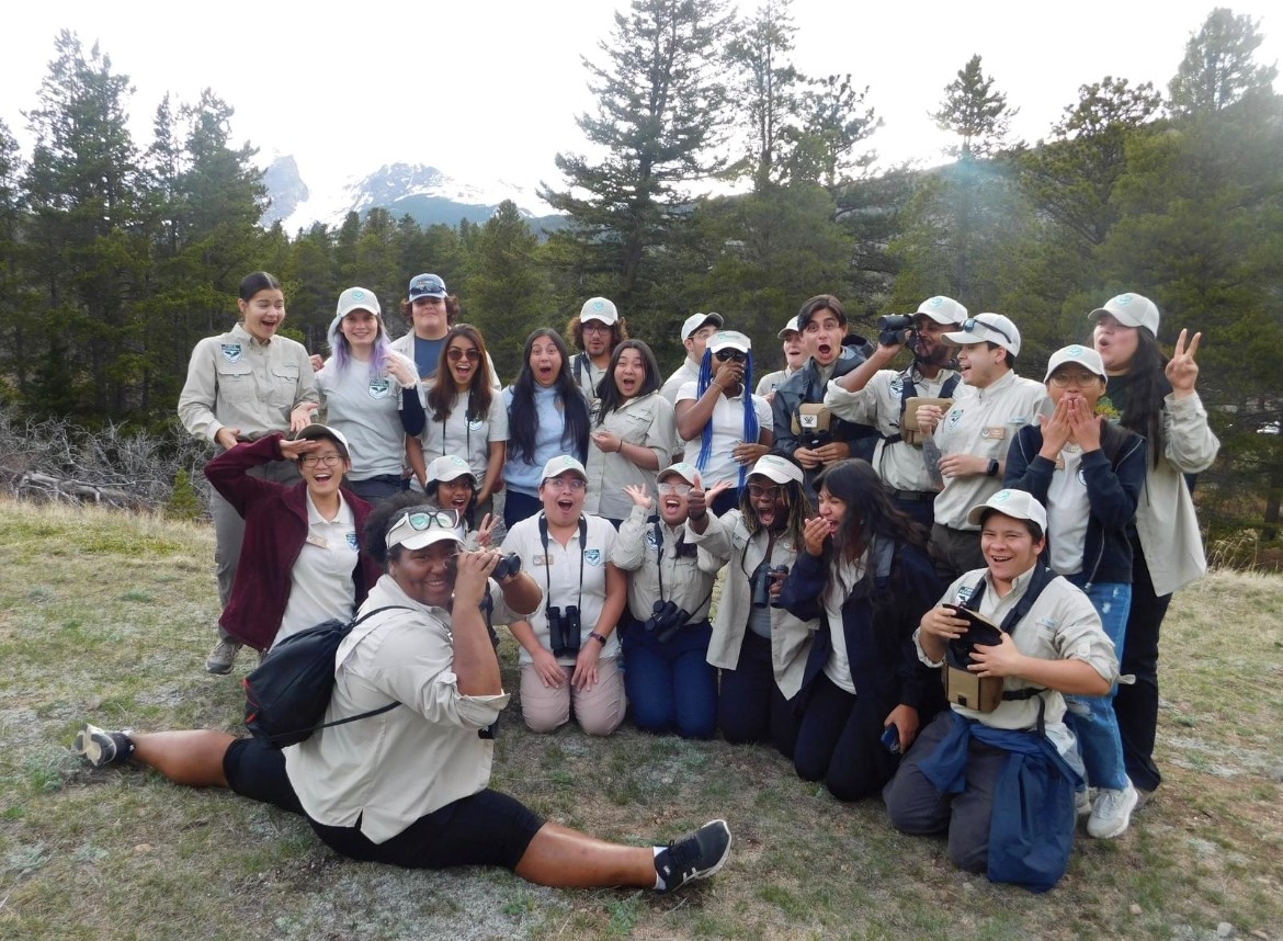 A group posing for a photo with one in the front split