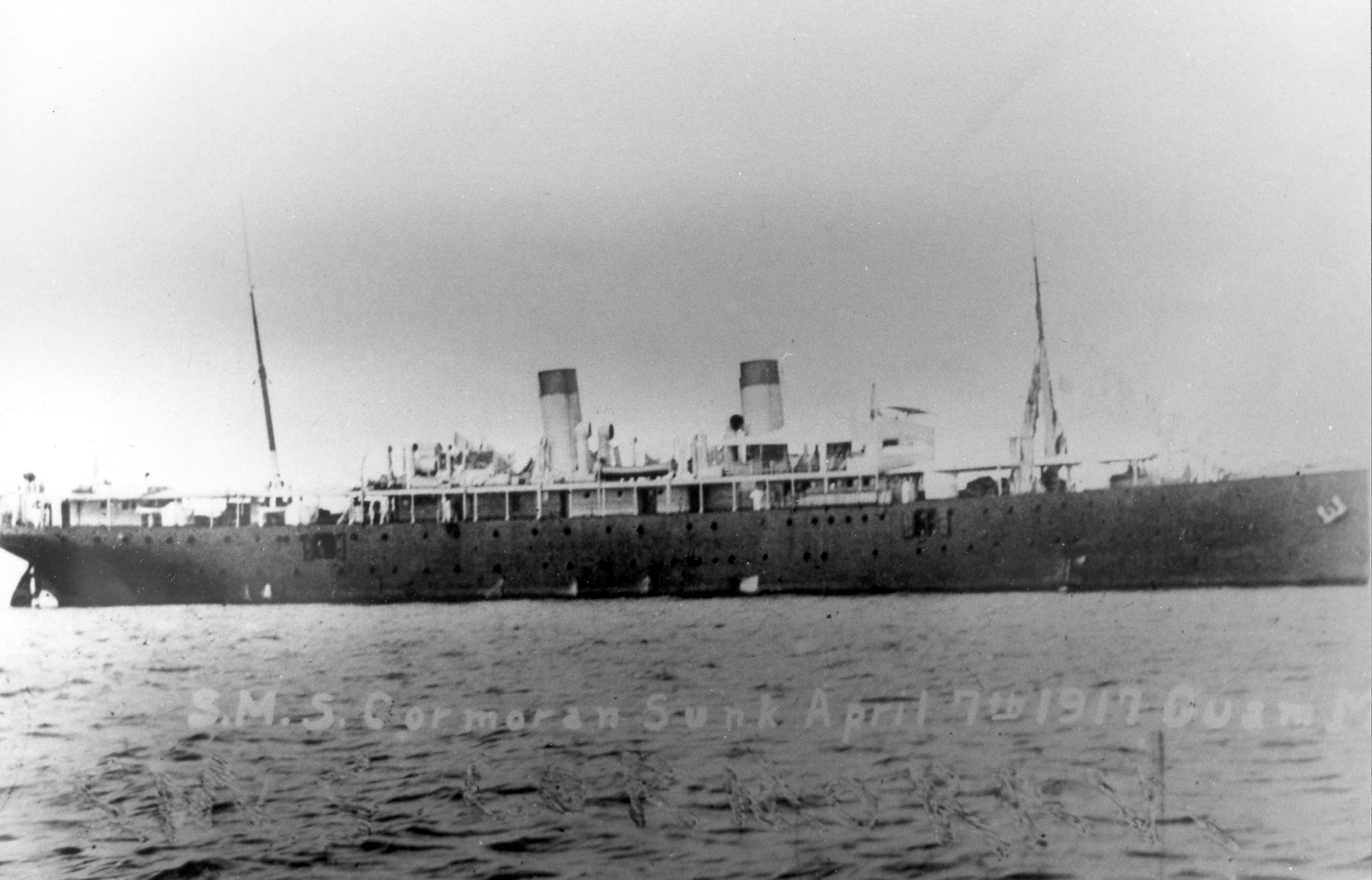 A large ship with two smokestacks and two masts.