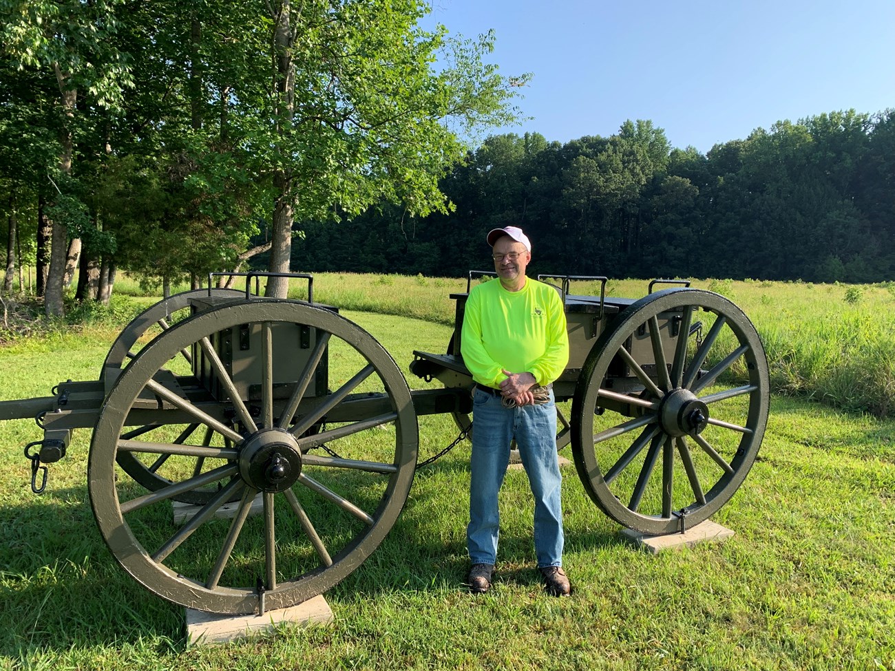 Calvin, volunteer, standing outside int front of a cannon limber.