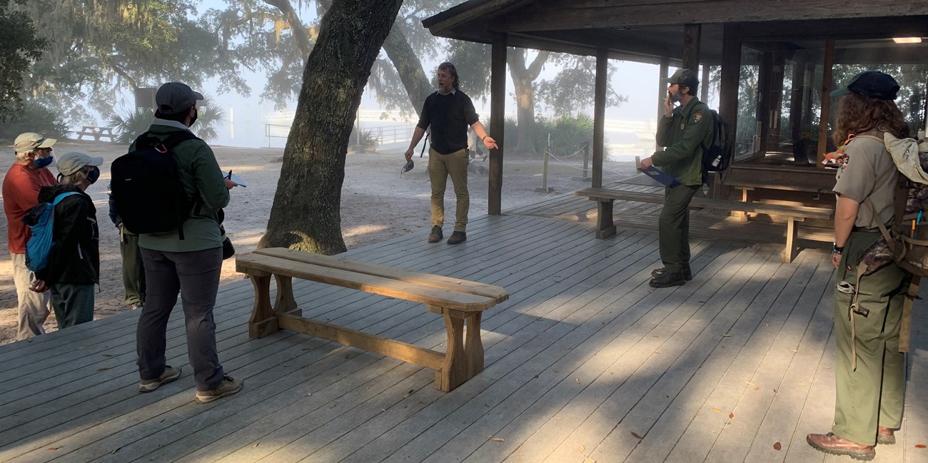 People standing in a circle on a platform