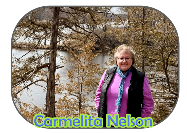 Volunteer Carmelita Nelson standing in the woods in front of the St. Croix River.