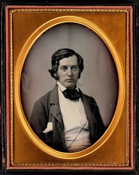 Portrait of Charles Sumner, a White man in a dark suit and white shirt.