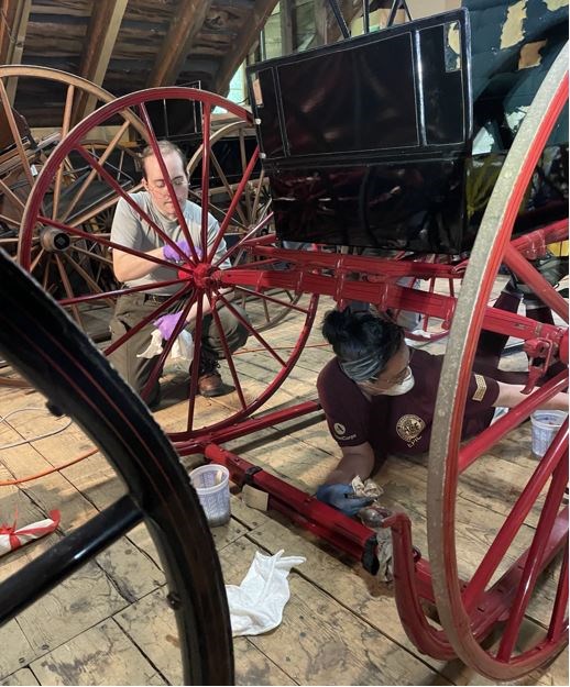 curatorial staff clean historic carriages