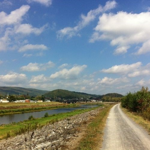 Scenic view of the towpath, mountains, and blue sky in Cumberland, Maryland.