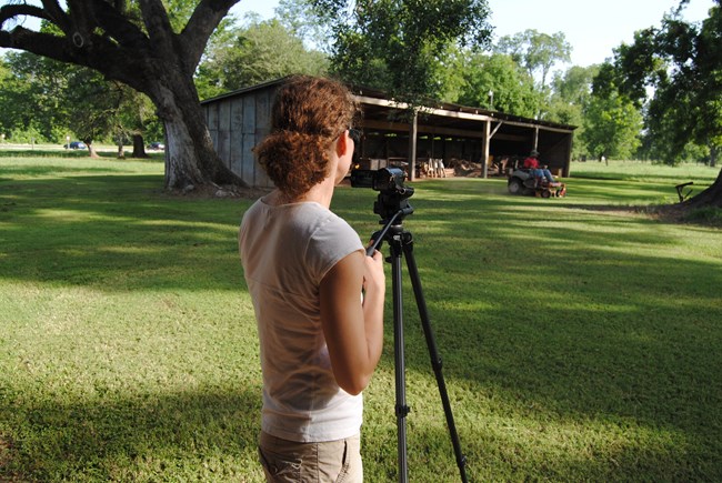 Stephanie Nelson is recording footage for the historic landscape maintenance training video.